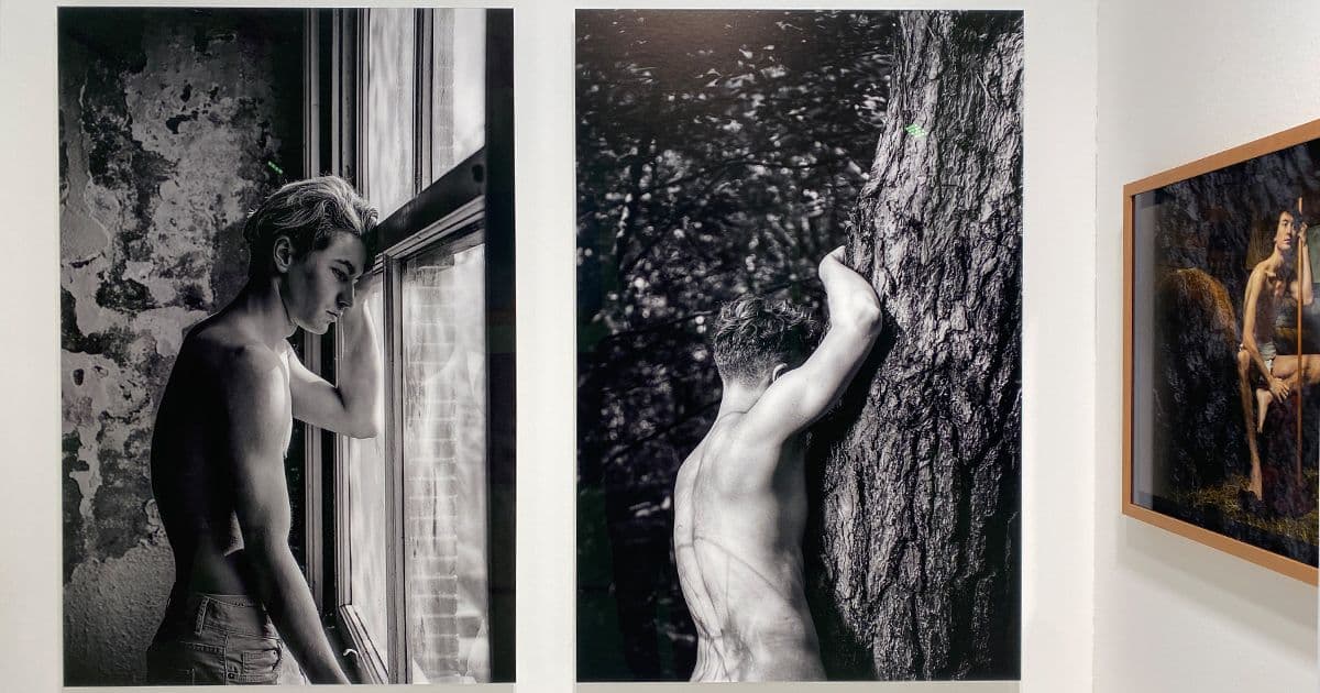 Three fine art photography works by Arjan Spannenburg displayed at PAN Amsterdam. From left to right: a black-and-white portrait of a man looking out a window (Ingrained), a monochrome study of a man leaning against a tree (Revival), and a framed colour portrait with religious iconography (John the Baptist)